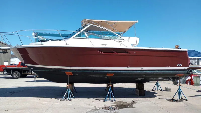 The Image of 2004 Tiara Yachts 2900 Coronet in storage, featuring a sleek red and white design. - 0