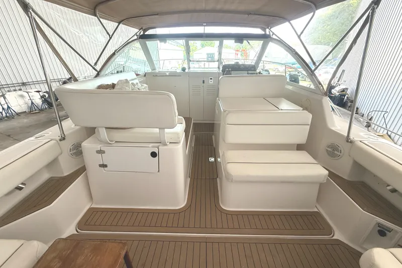 Slide: The Image of 2004 Tiara Yachts 2900 Coronet interior with white seating and wooden flooring. - 18