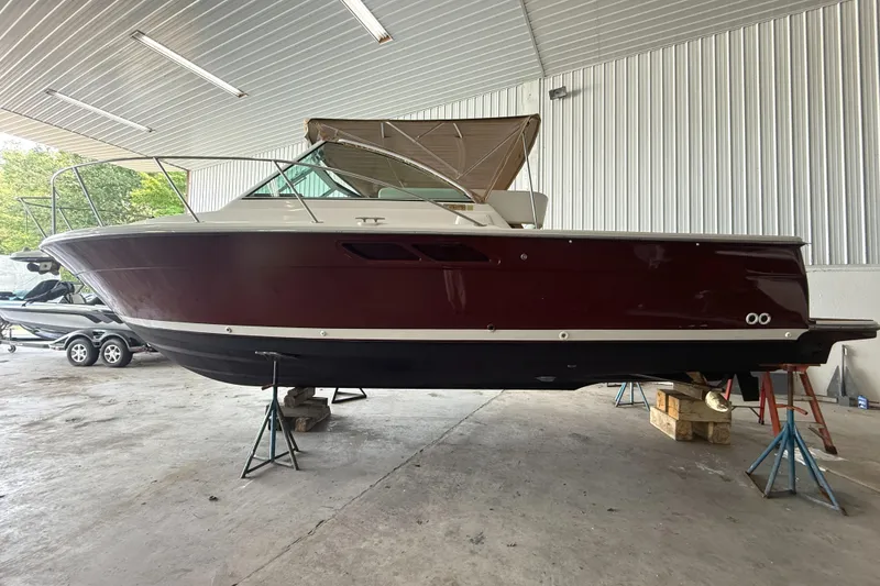 Slide: The Image of 2004 Tiara Yachts 2900 Coronet propellers and hull on stands in a workshop. - 6