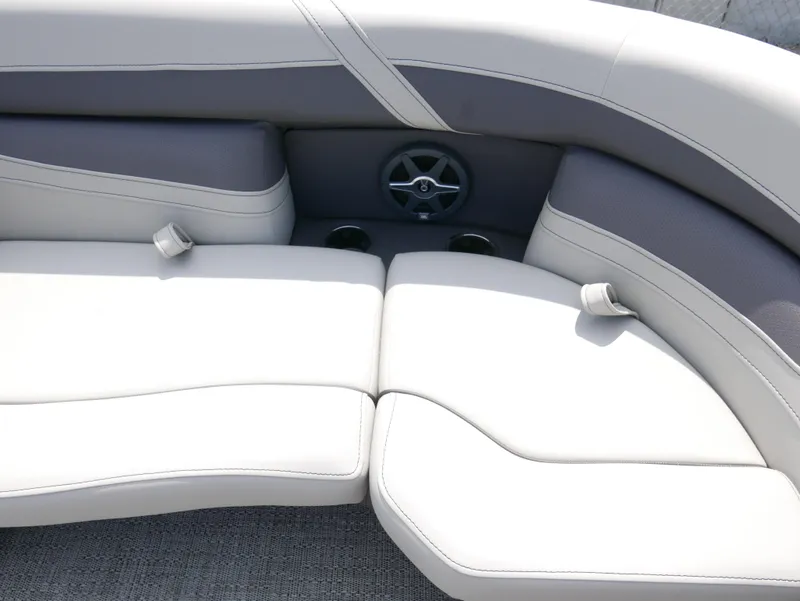 Slide: The Image of 2025 Barletta Cabrio 24UE boat interior with plush seating and cup holders. - 11