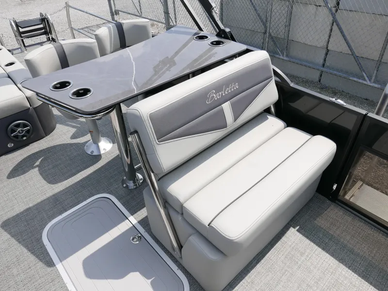 Slide: The Image of 2025 Barletta Cabrio 24UE boat interior with sleek seating and table design. - 15
