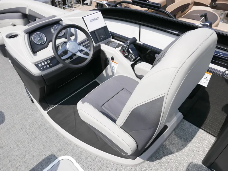 Slide: The Image of 2025 Barletta Cabrio 24UE boat cockpit with modern steering and controls. - 19