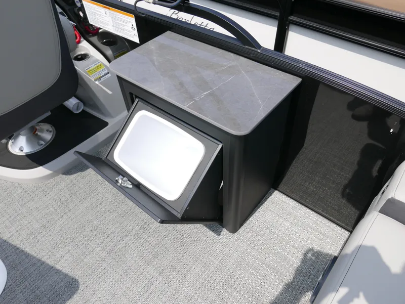 Slide: The Image of Barletta Cabrio 24UE 2025 boat interior with storage compartment and seating area. - 23