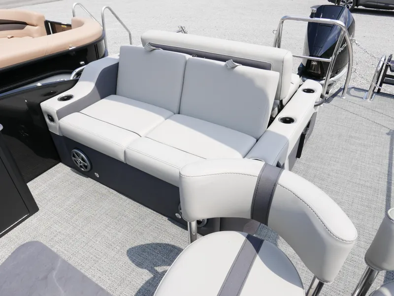 Slide: The Image of 2025 Barletta Cabrio 24UE boat interior with plush seating and cup holders. - 33