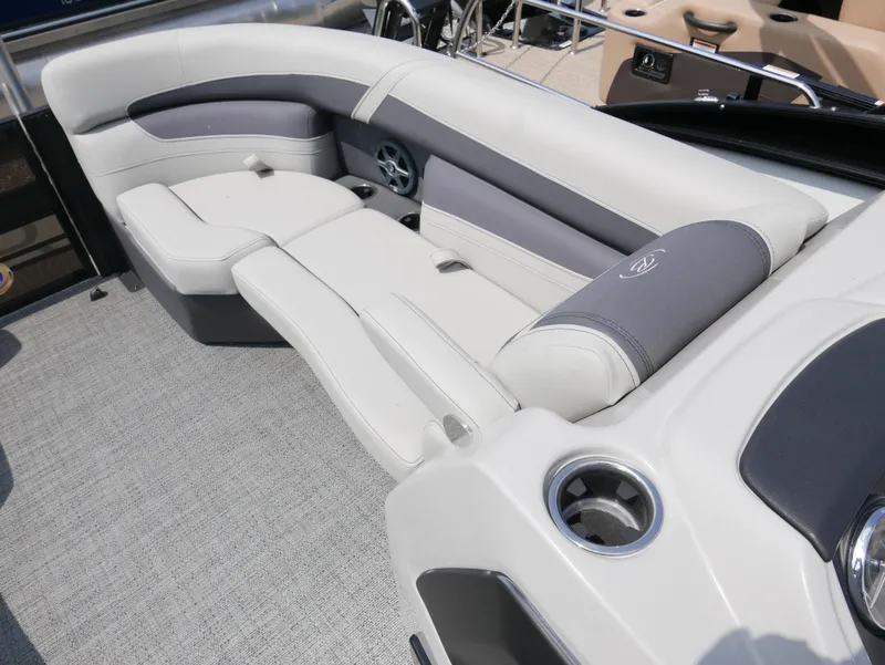 Slide: The Image of 2025 Barletta Cabrio 24UE boat interior with luxurious seating and cup holders. - 8