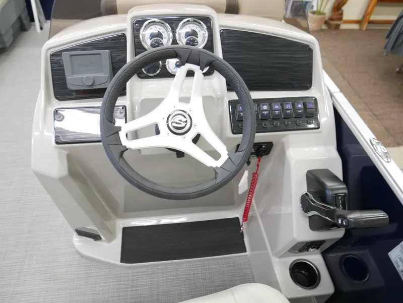 Slide: The Image of 2025 Sylvan Mirage 8520 LZ boat dashboard with steering wheel and control panel. - 10