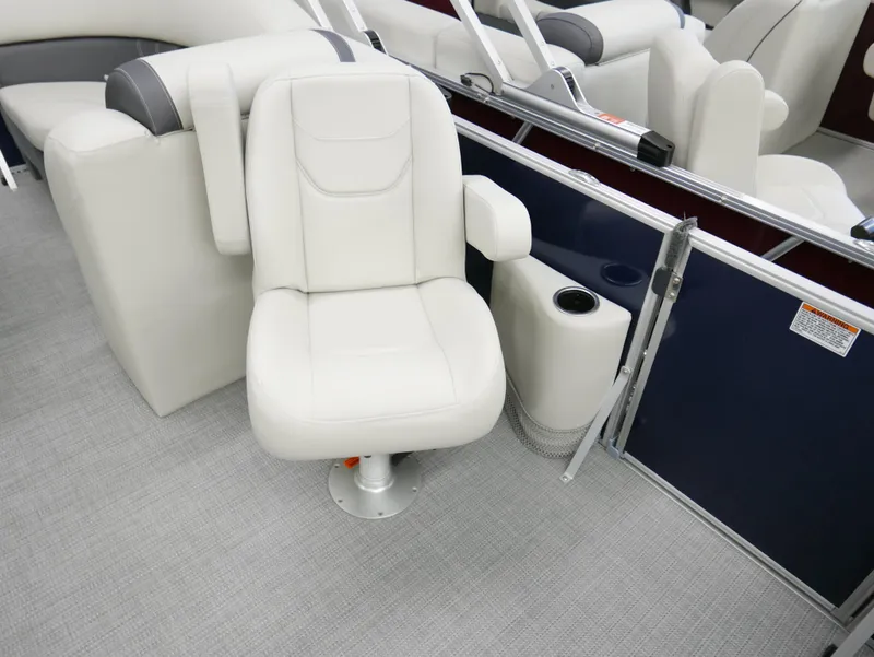 Slide: The Image of 2025 Sylvan Mirage 8520 LZ boat interior with white captain's chair and cup holder. - 7