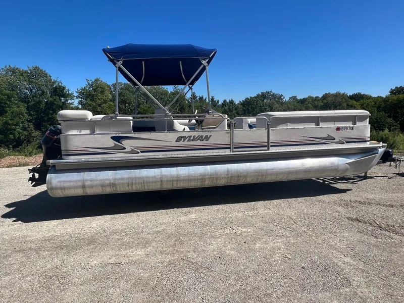 Slide: The Image of 2003 Sylvan Mirage pontoon boat with canopy on a sunny day. - 13