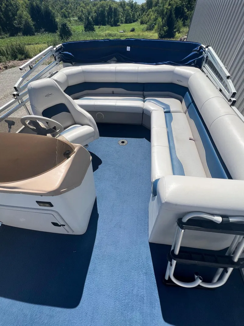 Slide: The Image of 2003 Sylvan Mirage pontoon boat with spacious seating and blue flooring. - 2
