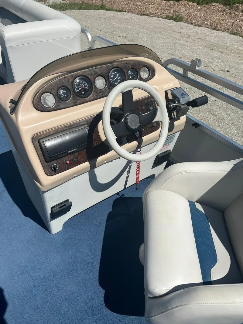 Slide: The Image of 2003 Sylvan Mirage boat dashboard with steering wheel and gauges. - 4