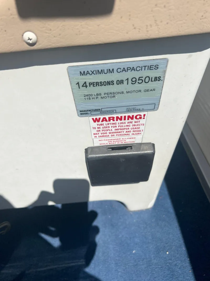 Slide: The Image of 2003 Sylvan Mirage capacity label, maximum 14 persons or 1950 lbs, warning notice visible. - 5