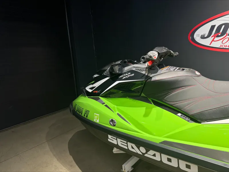 Slide: The Image of 2017 Sea-Doo GTR-X 230, green and black jet ski, showroom display. - 1