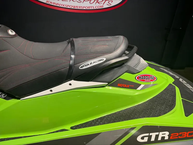 Slide: The Image of 2017 Sea-Doo GTR-X 230 jet ski, green and black design, close-up of seat and branding. - 3