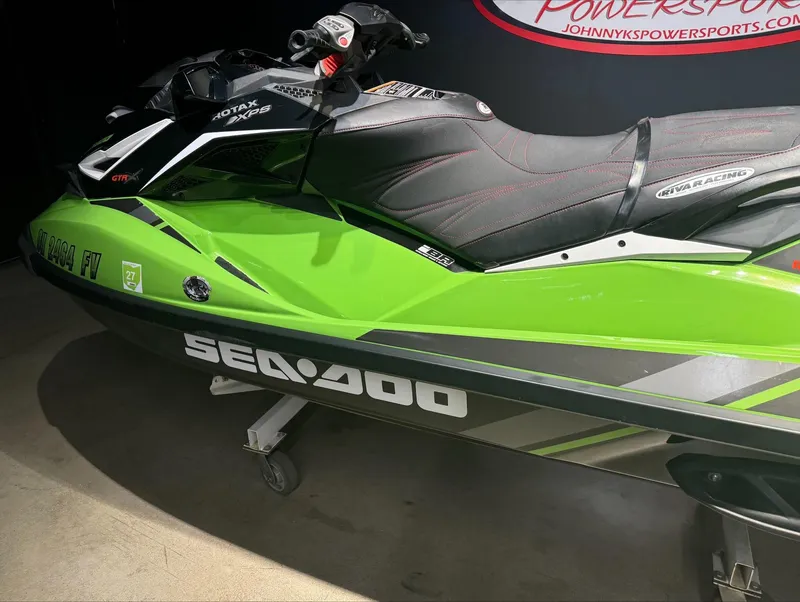 Slide: The Image of 2017 Sea-Doo GTR-X 230 in vibrant green, displayed indoors. - 4