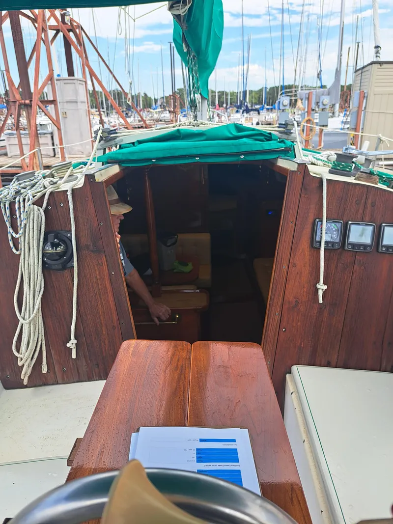 Slide: The Image of 1979 Newport Mark II sailboat interior with wooden finish and nautical equipment. - 11