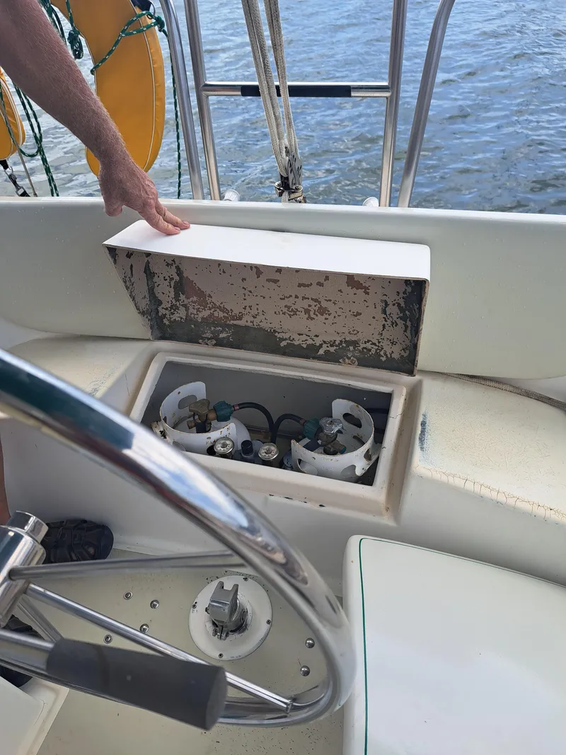 Slide: The Image of 1979 Newport Mark II sailboat cockpit with open storage compartment. - 15