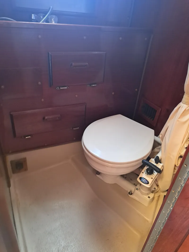 Slide: The Image of 1979 Newport Mark II boat bathroom with wooden cabinetry and marine toilet. - 17