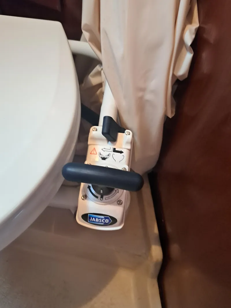 Slide: The Image of Jabsco marine toilet pump handle in a 1979 Newport Mark II boat bathroom. - 18