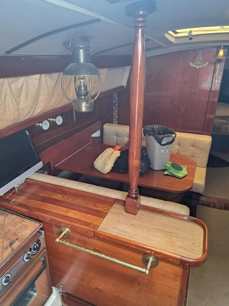Slide: The Image of 1979 Newport Mark II yacht interior with wooden furnishings and cozy seating area. - 29