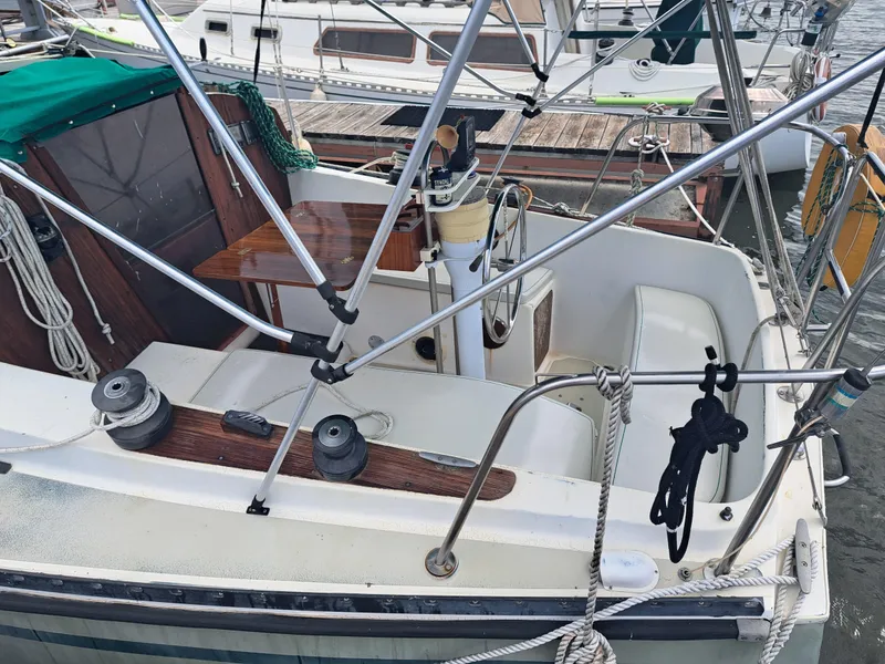 Slide: The Image of 1979 Newport Mark II sailboat cockpit with steering wheel and rigging. - 3