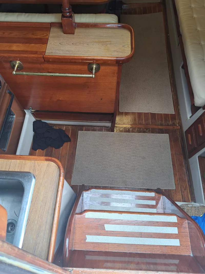 Slide: The Image of Interior of 1979 Newport Mark II sailboat with wooden cabinetry and carpeted flooring. - 30