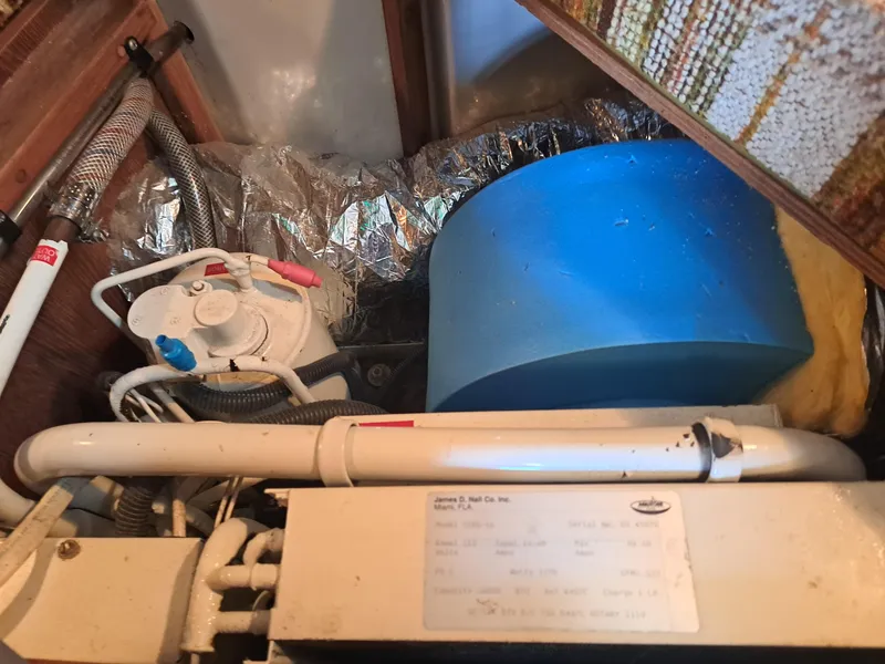 Slide: The Image of 1979 Newport Mark II interior showing plumbing and blue water tank. - 31