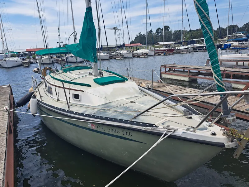 Slide: The Image of 1979 Newport Mark II sailboat docked at marina with green accents. - 6