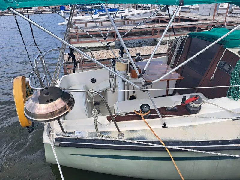Slide: The Image of 1979 Newport Mark II sailboat docked, featuring a spacious cockpit and canopy. - 7
