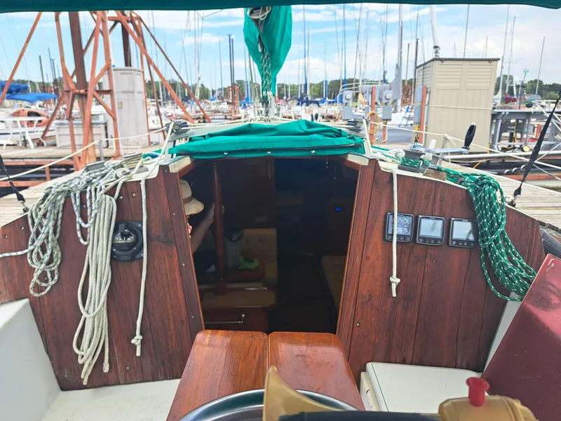 Slide: The Image of Interior view of a 1979 Newport Mark II sailboat docked at a marina. - 8