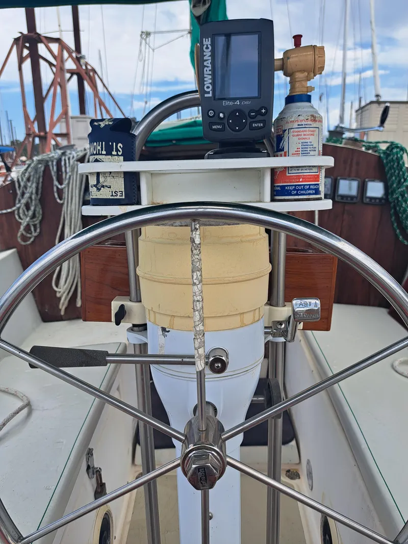 Slide: The Image of 1979 Newport Mark II sailboat helm with navigation equipment and steering wheel. - 9