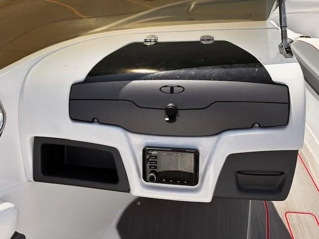Slide: The Image of Dashboard of 2023 Tahoe 210 S Limited boat with control panel and storage compartments. - 11