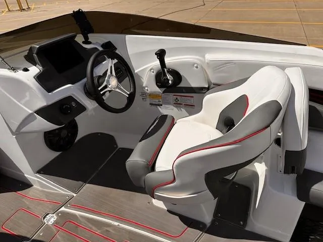 Slide: The Image of 2023 Tahoe 210 S Limited boat interior with steering wheel and captain's seat. - 12