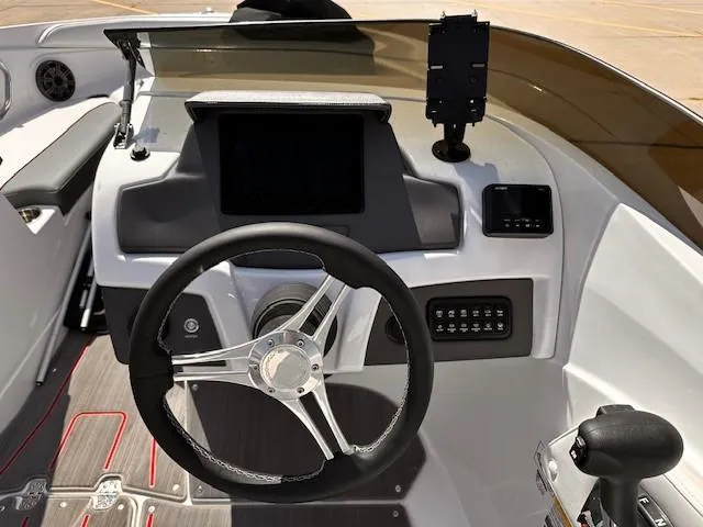 Slide: The Image of 2023 Tahoe 210 S Limited boat dashboard with steering wheel and control panel. - 13