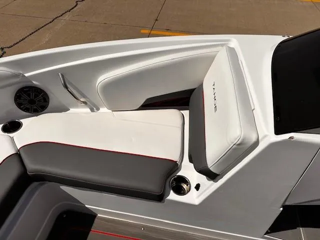 Slide: The Image of 2023 Tahoe 210 S Limited boat interior with white and gray seating, cup holders, and speaker. - 17