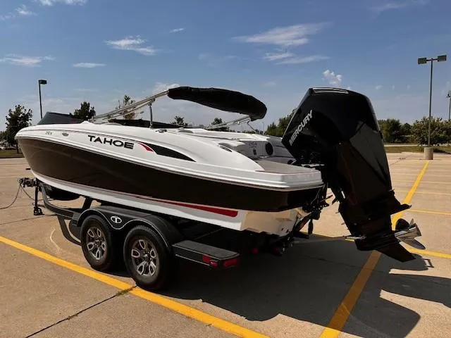 Slide: The Image of 2023 Tahoe 210 S Limited boat on trailer in parking lot, sunny day. - 2