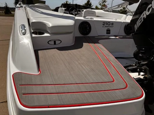 Slide: The Image of 2023 Tahoe 210 S Limited boat with sleek deck design and red accents. - 3