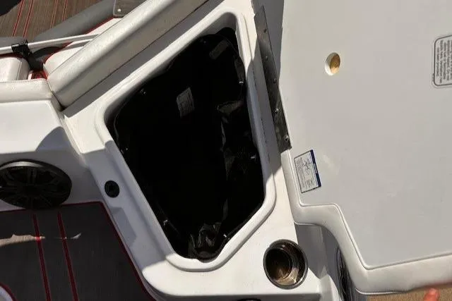 Slide: The Image of 2023 Tahoe 210 S Limited boat storage compartment with cup holder and speaker. - 5