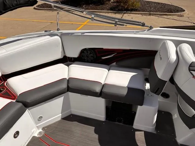 Slide: The Image of 2023 Tahoe 210 S Limited boat interior with white and gray seating, red accents. - 8