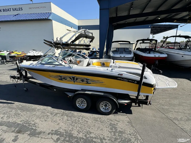 Slide: The Image of 2007 Nautique SV211 boat in yellow and white at a dealership. - 10