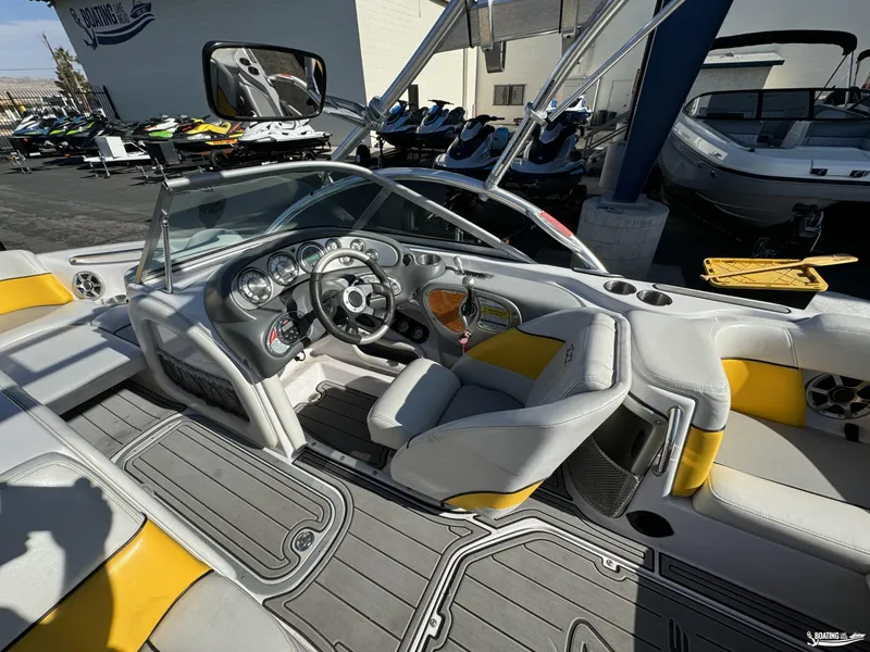 Slide: The Image of 2007 Nautique SV211 boat interior with steering wheel and seating, displayed at a dealership. - 5