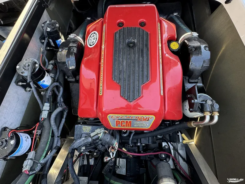 Slide: The Image of 2007 Nautique SV211 engine with red cover and visible wiring. - 8