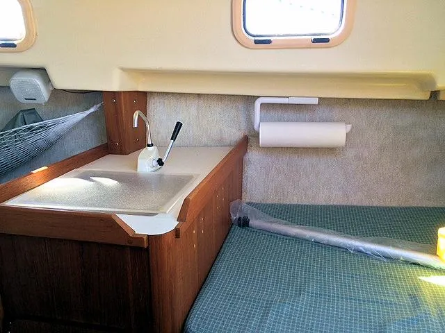 Slide: The Image of Interior of 1988 Quickstep 24 sailboat with sink, countertop, and bed. - 10