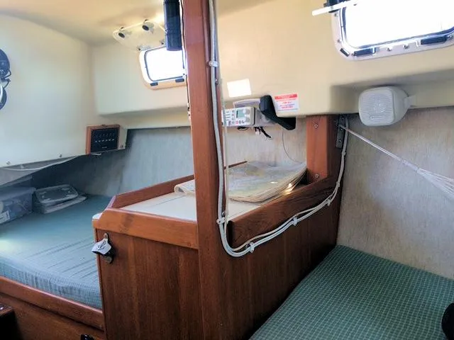 Slide: The Image of Interior of 1988 Quickstep 24 sailboat with navigation station and sleeping berths. - 11