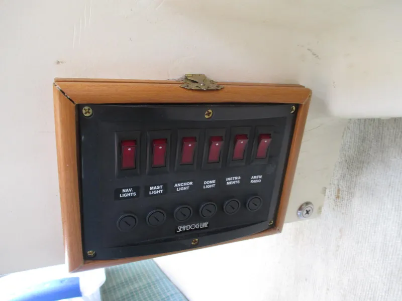 Slide: The Image of Control panel with switches for lights and devices on a 1988 Quickstep 24 boat. - 13