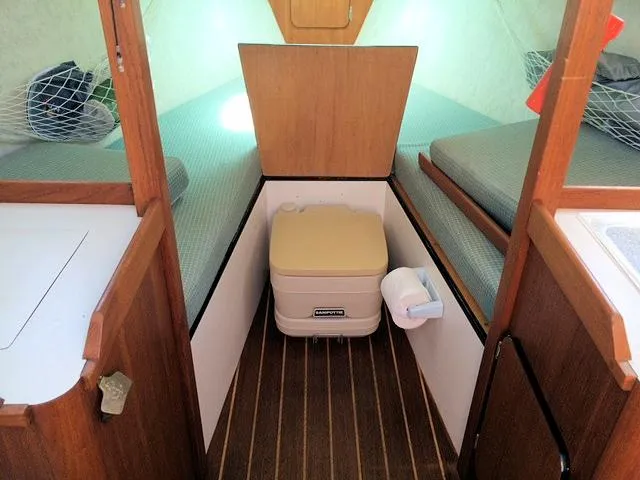 Slide: The Image of Interior of a 1988 Quickstep 24 sailboat with compact cabin and portable toilet. - 8
