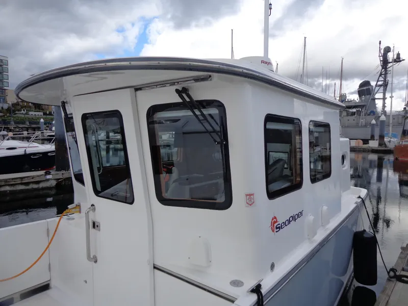 Slide: The Image of 2020 SeaPiper Pilothouse boat docked at marina under cloudy sky. - 11