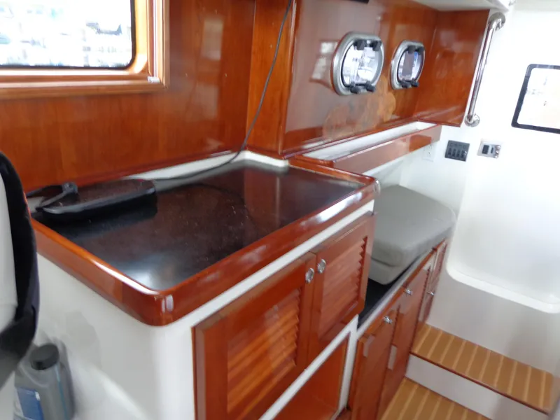 Slide: The Image of 2020 SeaPiper Pilothouse interior with wooden cabinetry and black countertop. - 18