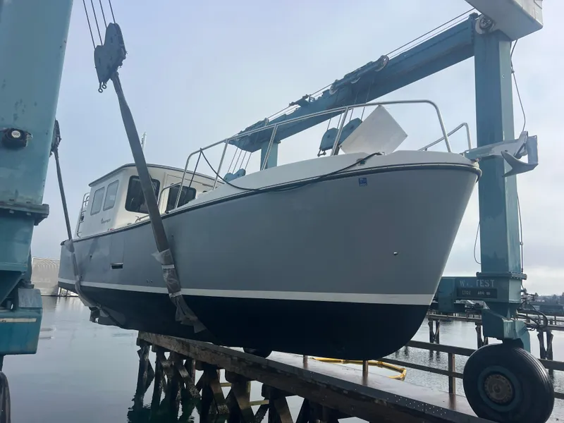 Slide: The Image of 2020 SeaPiper Pilothouse boat on a lift at a marina. - 2