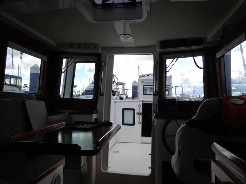 Slide: The Image of Interior view of 2020 SeaPiper Pilothouse boat with windows and seating. - 20