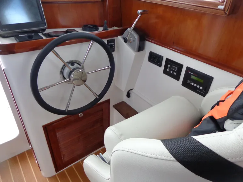 Slide: The Image of 2020 SeaPiper Pilothouse interior with steering wheel and control panel. - 23